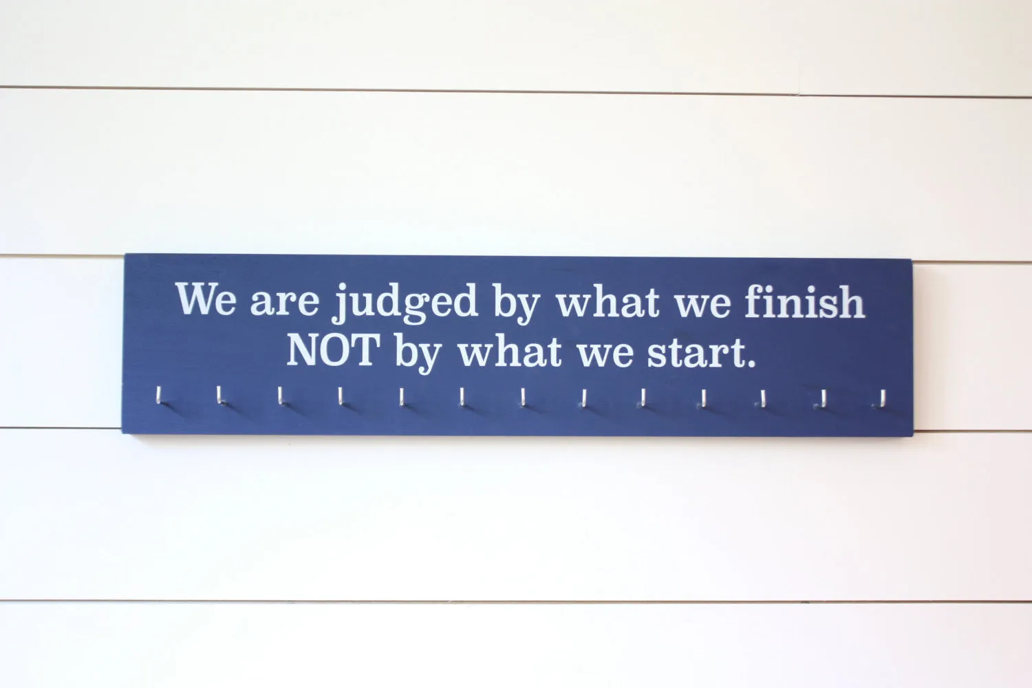 Medal Display - We are judged by what we finish NOT by what we start. - Large - Running / Triathlon / Ultra / Obstacle Race